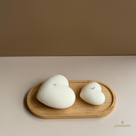 Two white textured candles on a wooden tray against a beige background, with 'Lavanore' branding. Heart sculptural soy wax candle designed for romantic gifting and elegant home décor