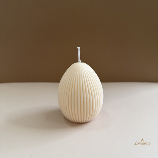 Textured candle on a plain surface with a brown background