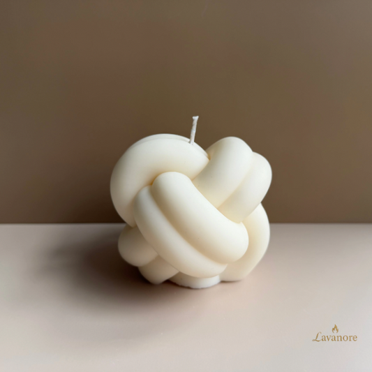 Knot-shaped candle on a neutral background with 'Lavanore' branding. Knot sculptural soy wax candle designed for modern luxury home décor and gifting