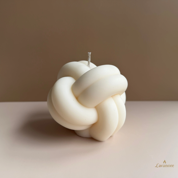 Knot-shaped candle on a plain background with 'Lavanore' branding. Knot sculptural soy wax candle designed for modern luxury home décor and gifting