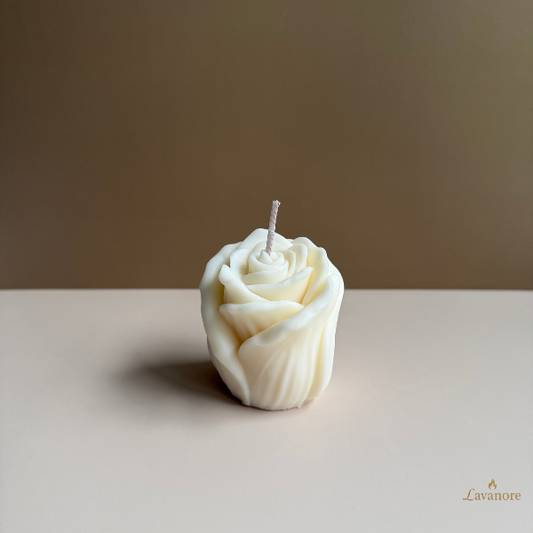 Rose-shaped candle on a plain surface with a neutral background. Floral sculptural soy wax candle designed for romantic gifting and elegant home décor