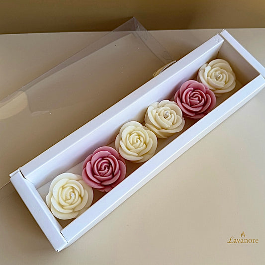 Decorative candle roses in a white box with clear lid on a beige surface, brand 'Lavanore' visible. Rose Mini Gift Box sculptural rose soy wax candle set of six for luxury gifting