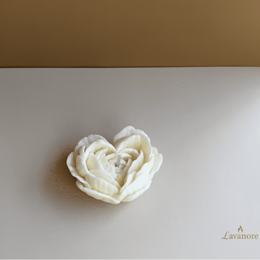 Heart in Bloom sculptural soy wax candle with layered petal design for luxury gifting. White rose-shaped object on a beige background with 'Lavanore' branding.