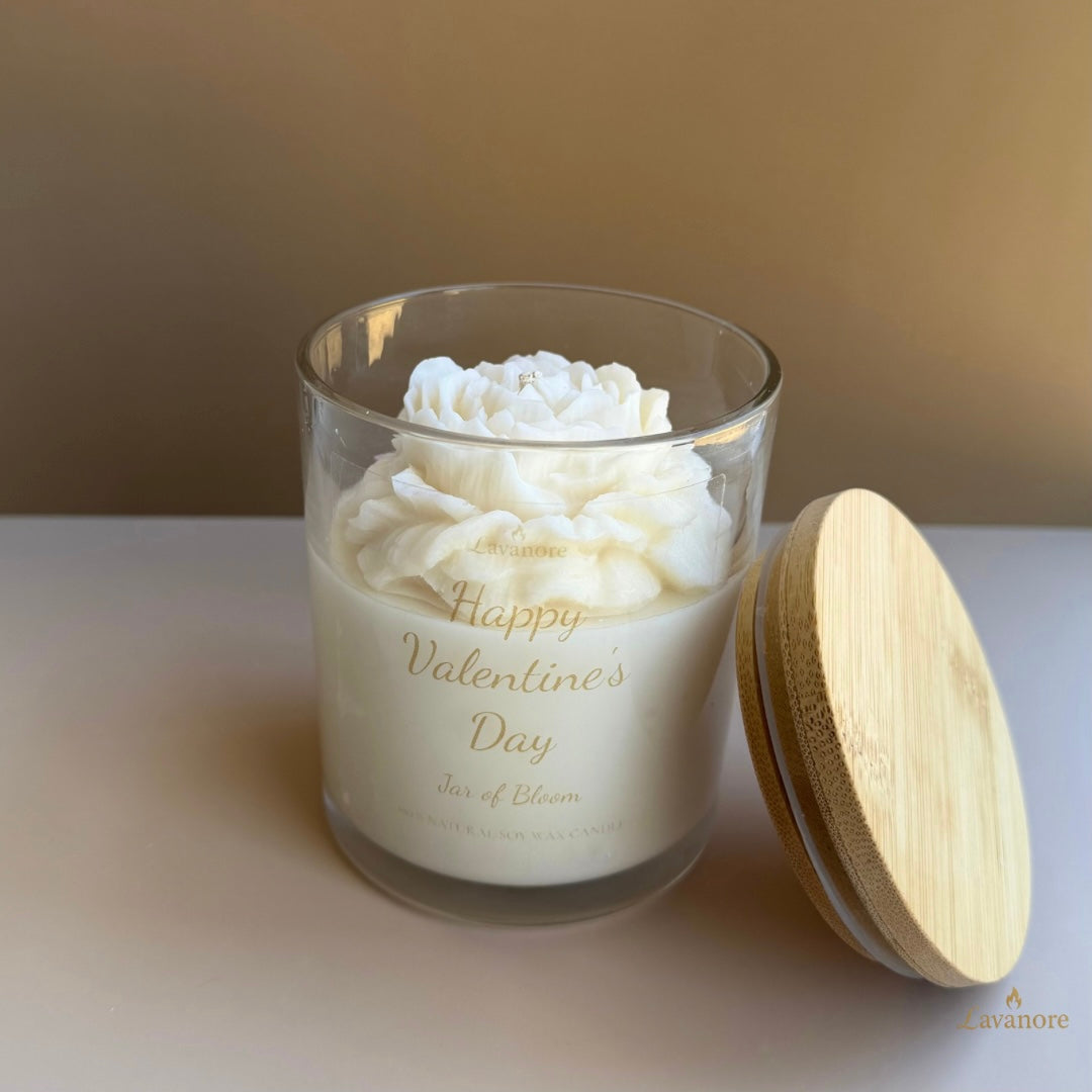 Jar of Bloom peony sculptural soy wax candle in glass jar for luxury gifting and décor. Candle with wooden lid labeled 'Happy Valentine's Day' on a neutral background. luxury peony soy wax candle gift in glass jar