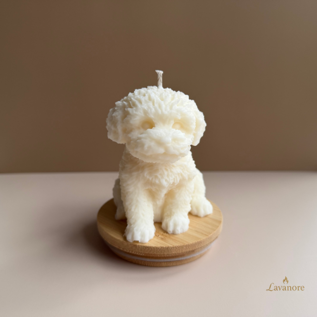 Dog-shaped candle on a wooden base with a plain background.Velour Puppy sculptural soy wax candle designed for luxury gifting and cozy home décor