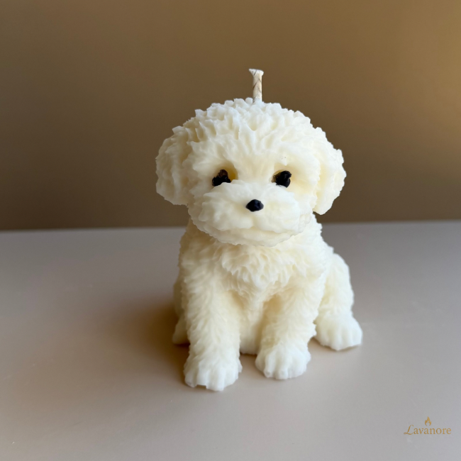 Candle shaped like a white dog on a beige background.Velour Puppy sculptural soy wax candle designed for luxury gifting and cozy home décor
