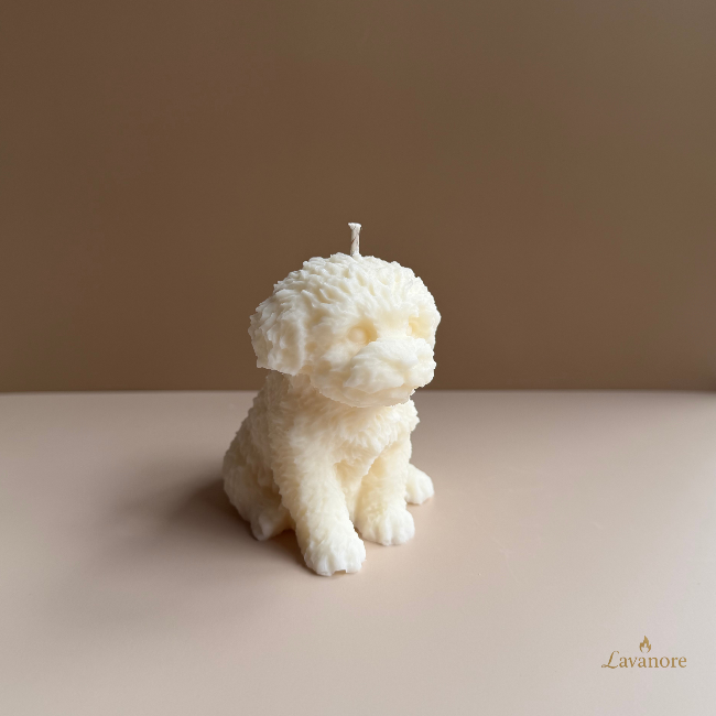 Candle shaped like a dog on a plain background with 'Lavanore' branding. Velour Puppy sculptural soy wax candle designed for luxury gifting and cozy home décor